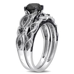 a black and white diamond ring set on top of each other with an intricate design