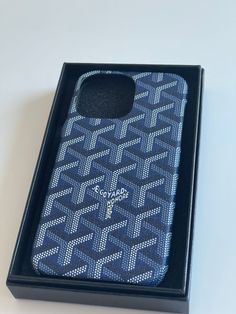 a cell phone case in a black box on a white table with a blue background