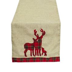 a red and white table runner with an image of two deers on the front