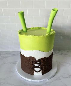 a cake with green and white icing on a plate