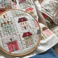 a close up of a cross stitch pattern on a table cloth with an embroidery hoop