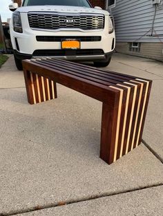 a bench sitting in front of a white truck