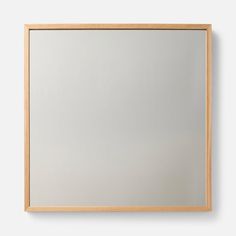 a wooden frame mirror hanging on the wall above it's reflection, with an empty space for text