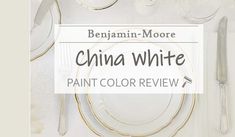 the china white paint color is shown with gold trimmings and silverware on it