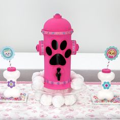 a pink toy fire hydrant sitting on top of a table