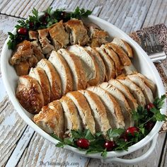 a platter filled with sliced turkey and cranberries