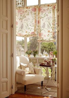 an open door leading to a living room with a chair and table in front of it