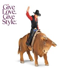 a toy man riding on the back of a bull with his arms in the air