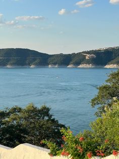 there is a bench overlooking the water and hills