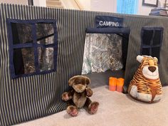 a stuffed animal sitting next to a tent