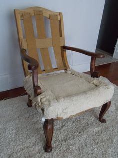 an old chair is sitting on the carpet