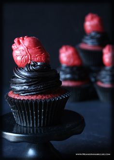 cupcakes with red frosting and decorations on top