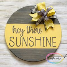 a wooden sign that says hey there sunshine with a yellow bow on the front and bottom