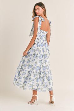 Channel sunny-day vibes in this romantic midi sundress topped by flirty shoulder ties and styled with a sultry ruched bust. • Chiffon floral print • Ruched bust • Light bra-cup • Tiered midi dress• Self tie shoulder straps• Back smocked • Back Zipper detail Cindy Dress, Flower Maxi Dress, Floral Bustier, Blue Florals, Bra Cup, Tiered Midi Dress, Flowing Skirt, Dresses By Length, Crop Top Sweater