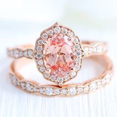 an oval shaped pink diamond ring set in rose gold with diamonds surrounding it and the words oval vintage floral bridal set in scalloped band