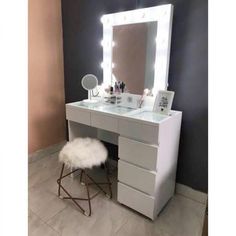 a white vanity with lighted mirror and stool