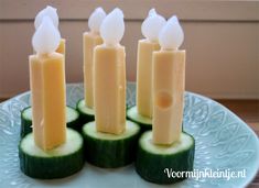 cucumber slices arranged on top of each other with candles sticking out of them