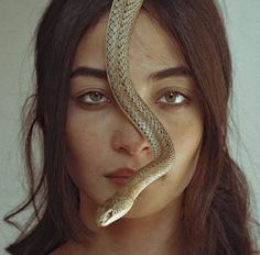 a woman with a snake on her head