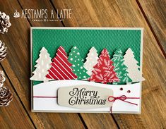 a merry christmas card with trees on it and a tag that says merry christmas in red, white and green