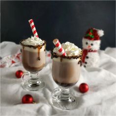 two glasses filled with hot chocolate and marshmallows