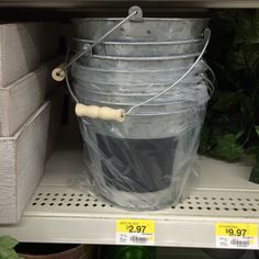 plastic buckets with handles are sitting on the shelf