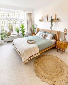 a bed room with a neatly made bed and a round rug on the floor next to it