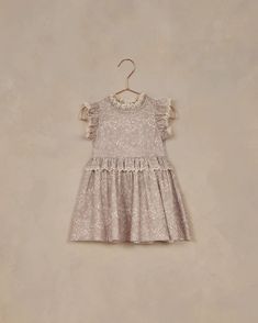 This enchanting dress features delicate ruffles at the neckline and waist with embroidered lace trim. A simple silhouette perfect for the sweetest of days. Zipper closure at the back.*Sizes 12m,18m, 2y include a coordinating bloomer.Featured in our 'lavender bloom' all over print on our 'lavender' hue.Care: Machine wash cold. Hang to Dry. Minor shrinkage may occur if tumble dried.Made of 100% Cotton Enchanting Dress, Alice Dress, Modern Cloth Nappies, Dress Lavender, Post Partum Outfits, Artist Outfit, Glitter Girl, Simple Silhouette, End Of Season Sale