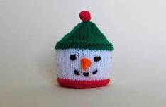 a knitted hat with a snowman's face on it