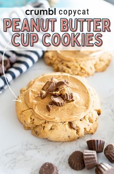 cookies with peanut butter frosting and chocolate chips on a marble counter top next to striped napkins