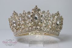 "FAST SHIPPING Beautiful sparkling crystal tiara plated gold. Perfect for your Quinceañera, Wedding, First Communion or Confirmation. It has a loop at the end of each side to attach it in your hair with bobby pins for added security. Approx. 3.75\" tall at its tallest point We usually ship within 1-2 business days. Style-RN205G" Big Gold Crown, White And Gold Quinceanera Crown, Gold Quince Crowns Big, Quince Crowns Gold, Gold Crown Quinceanera, Quinceanera Crowns Gold, Champagne Quince