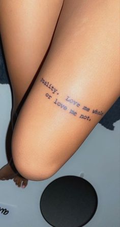 a woman's leg with the words, reality love me what or love me not written on it