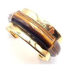 Tiffany & Co 18k Yellow Gold Tiger Eye Bangle Cuff Wide Bracelet 2002   Metal: 18k yellow gold  Length: 7"  Weight: 87.4 grams  Width: 1 1/4"  Hallmarks: 2002 Tiffany & Co 750 Hong Kong T3329ladd  Please reference the dimensions in the description for the best approximate dimensions. Designer Yellow Gold Cuff Bracelet, Luxury Yellow Gold Cuff Bangle, Designer Gold Cuff Bracelet, Designer Gold Cuff Bracelet With Polished Finish, Luxury Yellow Gold Cuff Bracelets, Luxury Gold Cuff Bracelet For Formal Events, Luxury Gold Cuff Bracelet For Formal Occasions, Designer Gold Cuff Bracelet Gift, Designer Gold Cuff Bracelet As Gift