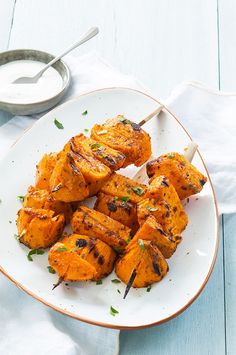 grilled chicken skewers on a white plate