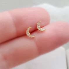 These tiny & sparkling Crescent Moon studs are waiting for you! Comfortable and secure, featuring a screw style flat back. The perfect addition to your unique Ear stack!• T H E • D E T A I L S • • 316L Surgical Steel or 14k Gold plated 316L Surgical Steel• Crescent moon measures 6.5mm x 4.5mm• Post is 16g and 1/4" (6mm) long• Thoughtfully packaged & ready for gift giving!• Handmade, just for you, in our sunny California Studio• Our 365 Guarantee: Our jewelry is guaranteed for 1 year afte Gold Moon Shaped Earrings For Gift, Gold Moon-shaped Earrings For Gift, Gold Moon-shaped Celestial Crystal Earrings, Celestial Gold Moon-shaped Crystal Earrings, Silver Earrings With Moon Charm For Anniversary, Sterling Silver Moon Charm Earrings For Anniversary, Dainty Moon-shaped Hypoallergenic Earrings, Dainty Moon Shaped Hypoallergenic Earrings, Dainty Hypoallergenic Moon-shaped Earrings