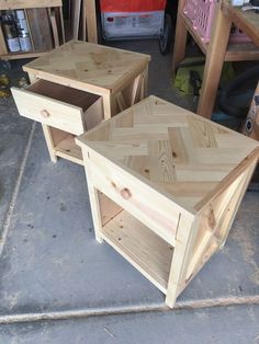 two wooden tables sitting next to each other on top of a cement floor in a garage