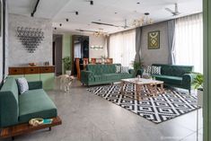 a living room filled with green couches and furniture