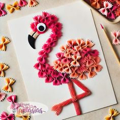 this is an image of a flamingo made out of pasta paper and some scissors