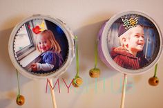 two cupcakes with pictures of children hanging from them on a wall next to each other