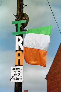 an irish flag hanging from a telephone pole