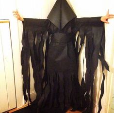 a person wearing a costume made out of black fabric