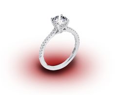 a white gold ring with diamonds on the side and a red light in the background