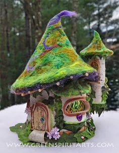 a green house with a purple roof in the snow