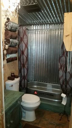 a bathroom with a tub, toilet and shower curtain in it's stall area