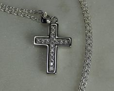 "Sterling Silver Cross Necklace. Item Description *A cubic zirconia set sterling silver cross pendant / necklace with a high polish edging.  *Optional 925 sterling silver 46cm/18\" belcher/rolo chain. Materials *925 Sterling Silver. *Cubic Zirconia. Dimensions *Width of the cross is approximately 12mm. *Height of the cross is approximately 16mm. *Weight approximately 1.1g Condition: *This item is new. Here are some links to more of our religious jewellery: St Christophers: www.etsy.com/uk/listing/847490823 www.etsy.com/uk/listing/844543771 www.etsy.com/uk/listing/830634894 Miraculous Medal: www.etsy.com/uk/listing/847500333 Crosses & Crucifix: www.etsy.com/uk/listing/847504027 www.etsy.com/uk/listing/844461773/ www.etsy.com/uk/listing/828018460 Please visit our shop to view the full range Silver Polished Cross Pendant, Nickel-free Sterling Silver Cross Pendant Earrings, Nickel-free Stainless Steel Cross Pendant Necklace, Nickel-free Sterling Silver Crucifix Jewelry, Nickel-free Sterling Silver Cross Pendant, Silver Cross Necklace, Sterling Silver Cross Necklace, Sterling Silver Cross Pendant, Silver Cross Pendant