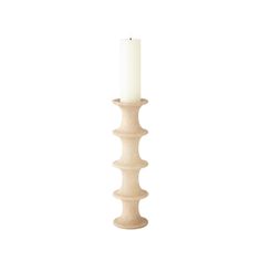 a tall wooden candle holder with a white candle in it's center on a white background