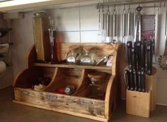 a kitchen area with wooden utensils and other items on display in the cabinet