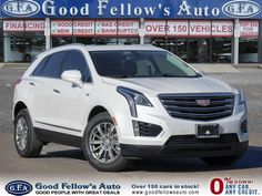 a white cadillac suv is parked in front of a dealership with the words good fellow's auto written on it