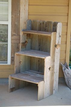 a wooden shelf sitting on the side of a house