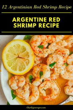 a white plate topped with shrimp next to a lemon wedge