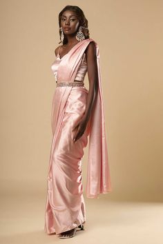 About this Product Saree: Ready to wear , Pre-stitched Saree Type: Ready to wear saree, Pre-stitched Saree Color: Pink Saree Fabric: Satin Belt: Belt sold separately Drape Style: Choose the drape style while order: Standard Open, Pleated or Gujarati Saree length: 5.5 meters Petticoat: Saree comes with an in-built butter crepe petticoat, no additional petticoat is required to wear with the saree. Sizing: Waist is adjustable +/- 1 size with a partial elastic waist band that falls under the drape f Petticoat Saree, Gujarati Saree, Bridesmaid Sarees, Reception Sarees, One Minute Saree, Formal Saree, Model Blouse, Saree With Belt, Saree Ideas